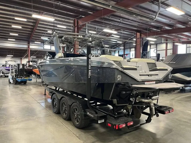 Slide: The Image of 2023 Nautique G25 boat in warehouse on trailer. - 4