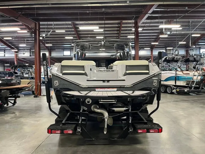 Slide: The Image of Rear view of a 2023 Nautique G25 boat in a warehouse. - 5