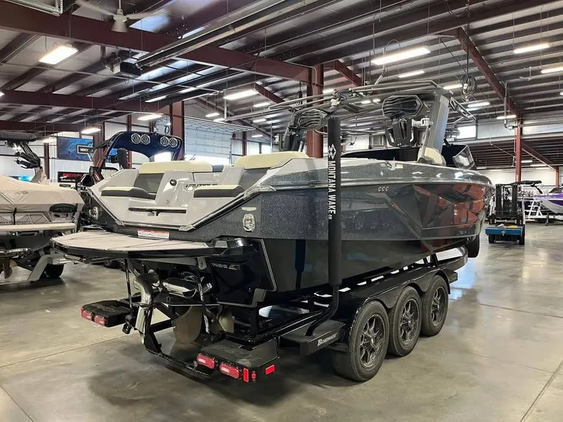 Slide: The Image of 2023 Nautique G25 boat on trailer in warehouse. - 6