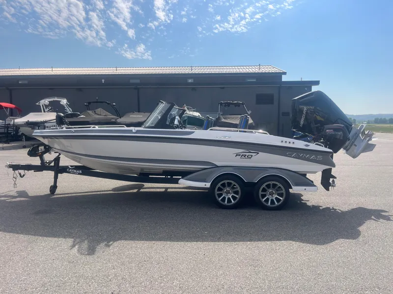 Slide: The Image of 2024 Caymas DV 22 boat on trailer under sunny skies. - 6