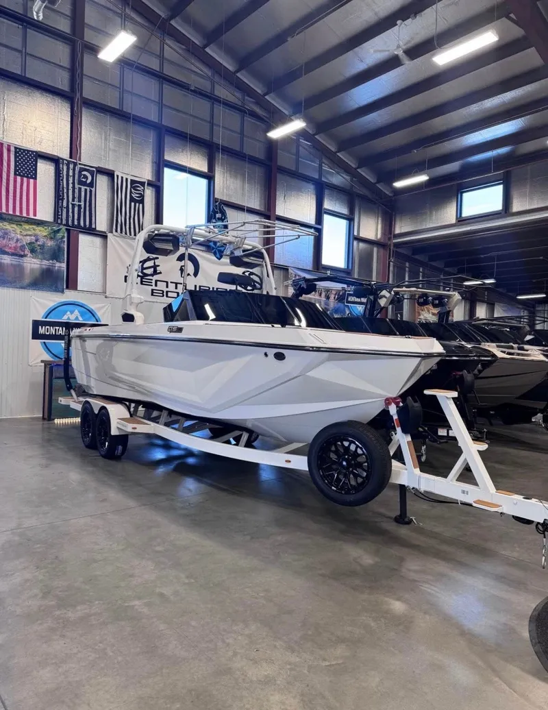 The Image of 2026 Nautique GS24 boat on trailer in showroom. - 1
