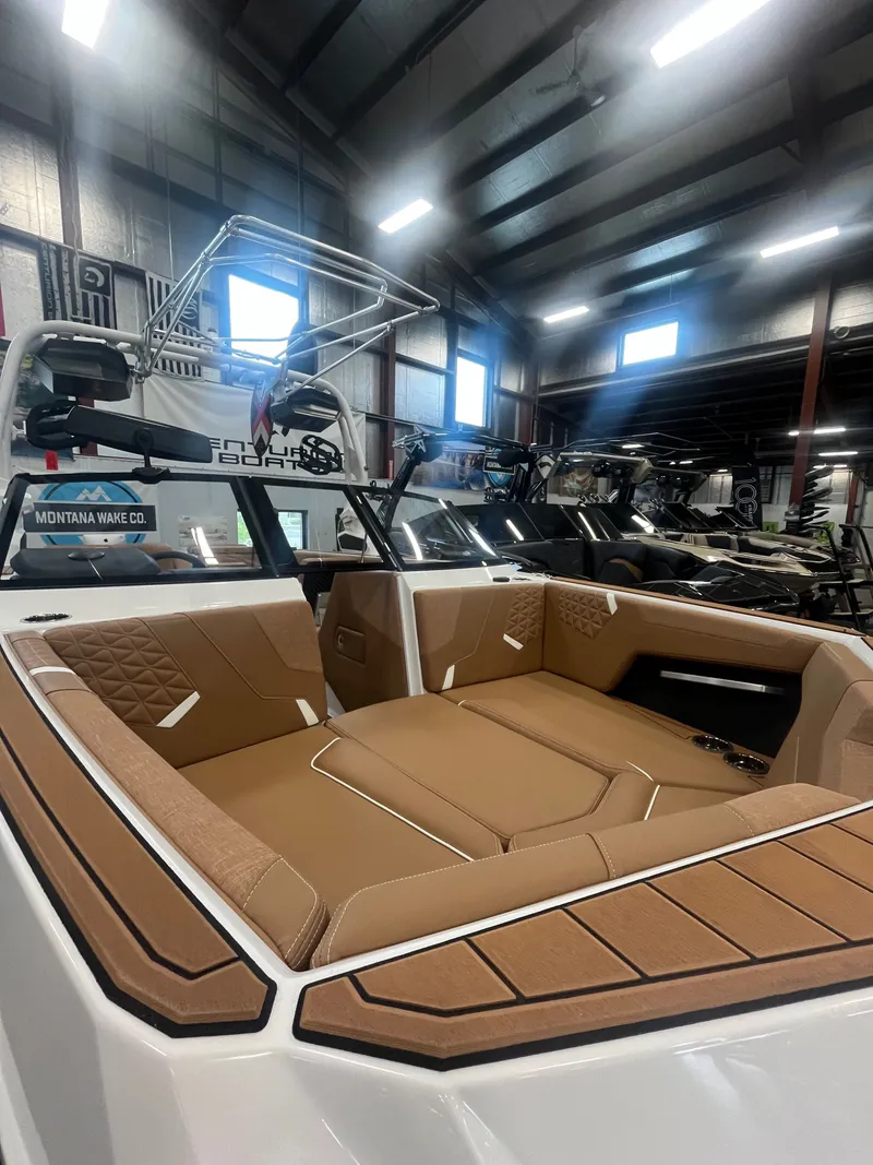 Slide: The Image of Interior of a 2026 Nautique GS24 boat in a warehouse. - 5