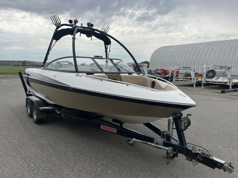 The Image of 2004 Malibu XTI boat on trailer, ready for adventure. - 1