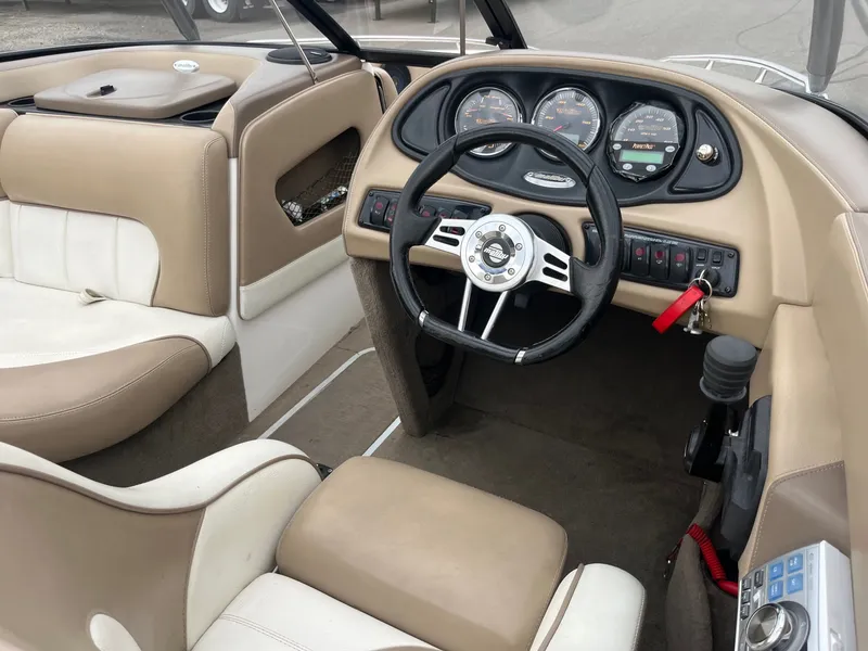 Slide: The Image of Interior of a 2004 Malibu XTI boat with steering wheel and dashboard. - 10