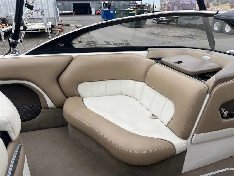Slide: The Image of Interior of a 2004 Malibu XTI boat with beige and white seating. - 11