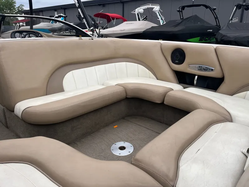 Slide: The Image of Interior of a 2004 Malibu XTI boat with beige and white seating. - 12