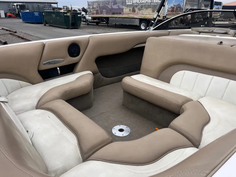 Slide: The Image of Interior of a 2004 Malibu XTI boat with beige and white seating. - 13