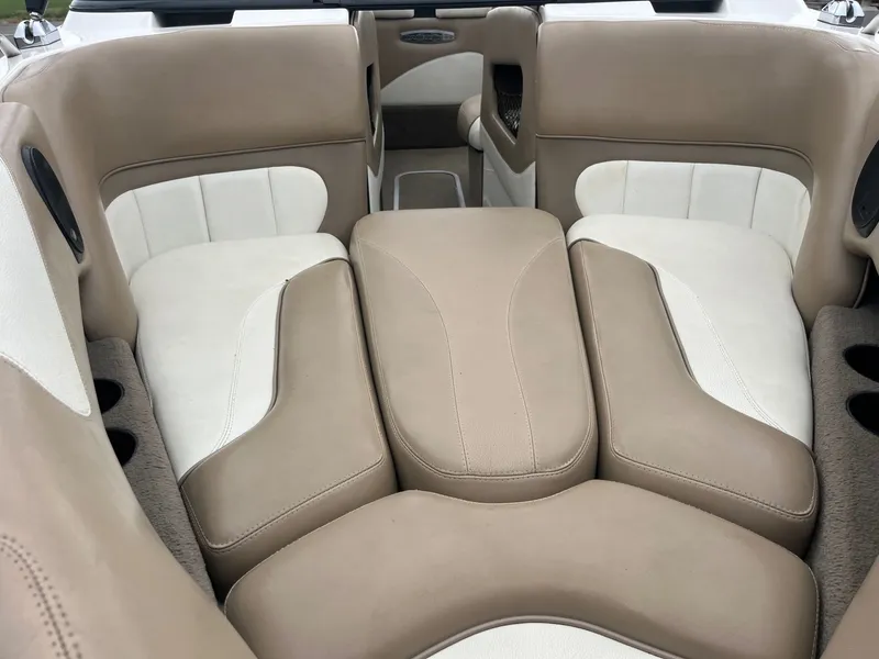 Slide: The Image of Interior of a 2004 Malibu XTI boat with beige and white seating. - 9