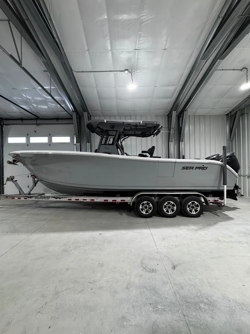 Slide: The Image of 2025 Sea Pro 292 DLX boat in warehouse on trailer. - 3