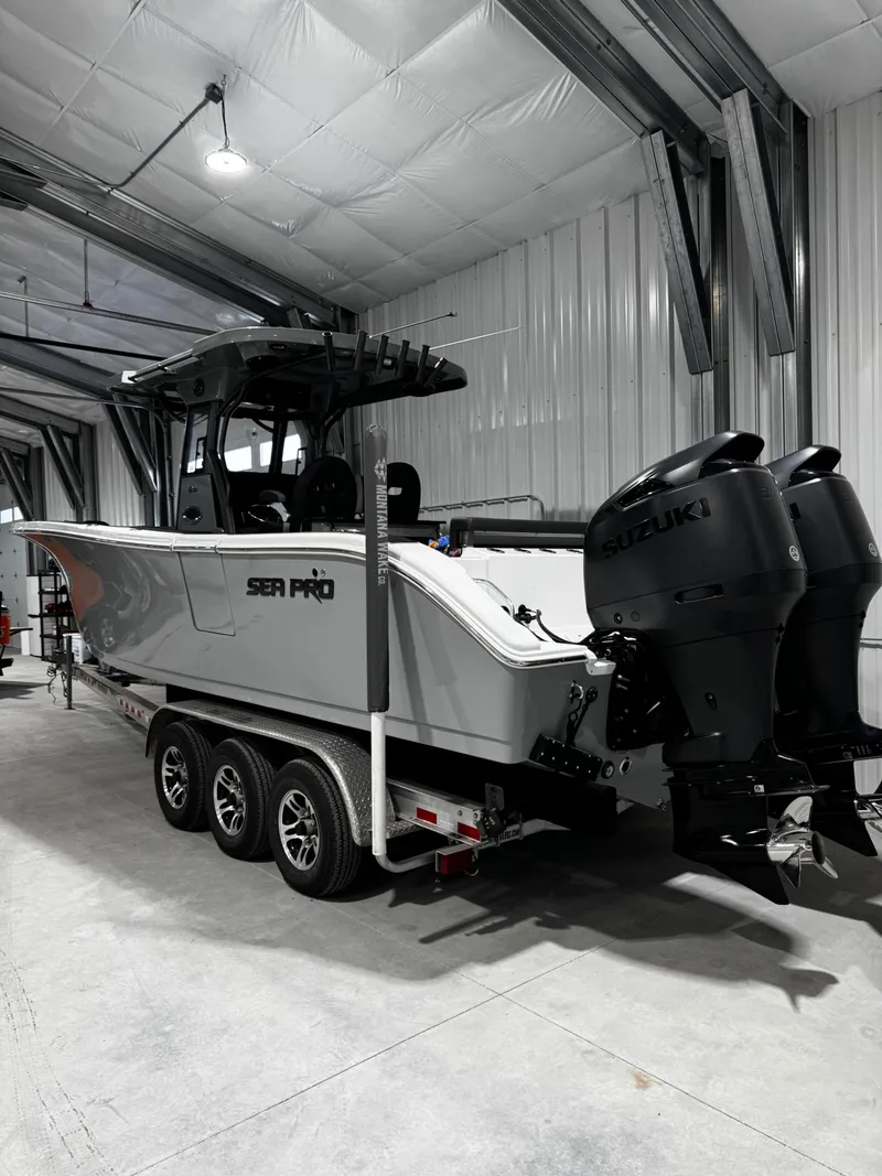 Slide: The Image of 2025 Sea Pro 292 DLX boat in warehouse with Suzuki engines. - 4
