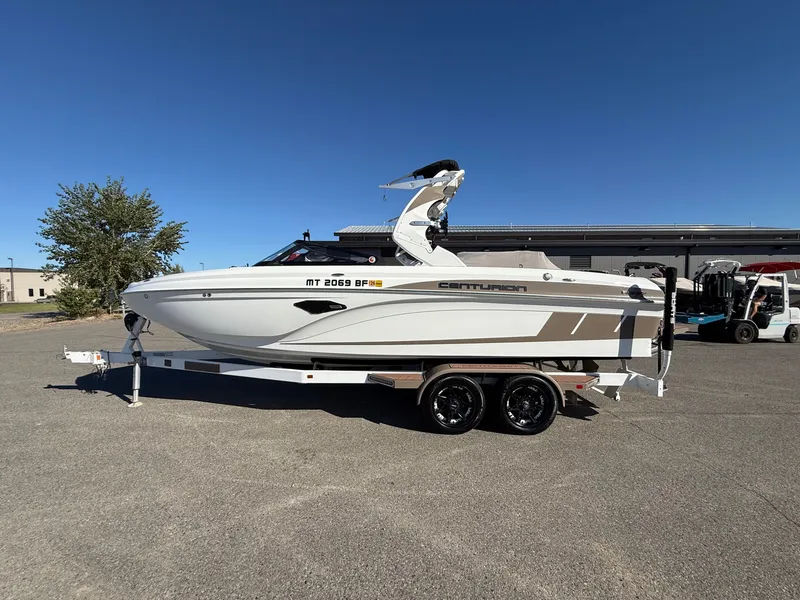 Slide: The Image of 2020 Centurion Ri237 boat on trailer under clear blue sky. - 3