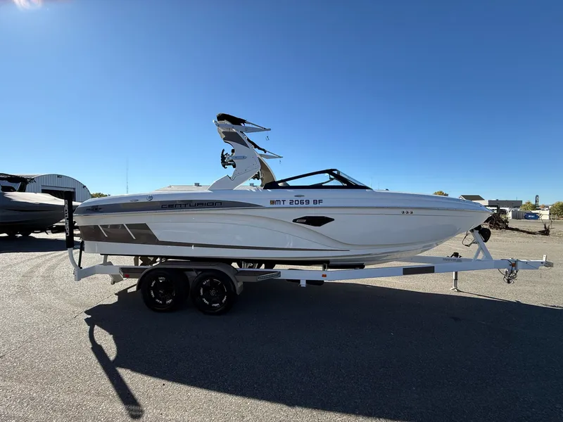 Slide: The Image of 2020 Centurion Ri237 boat on trailer under clear blue sky. - 7