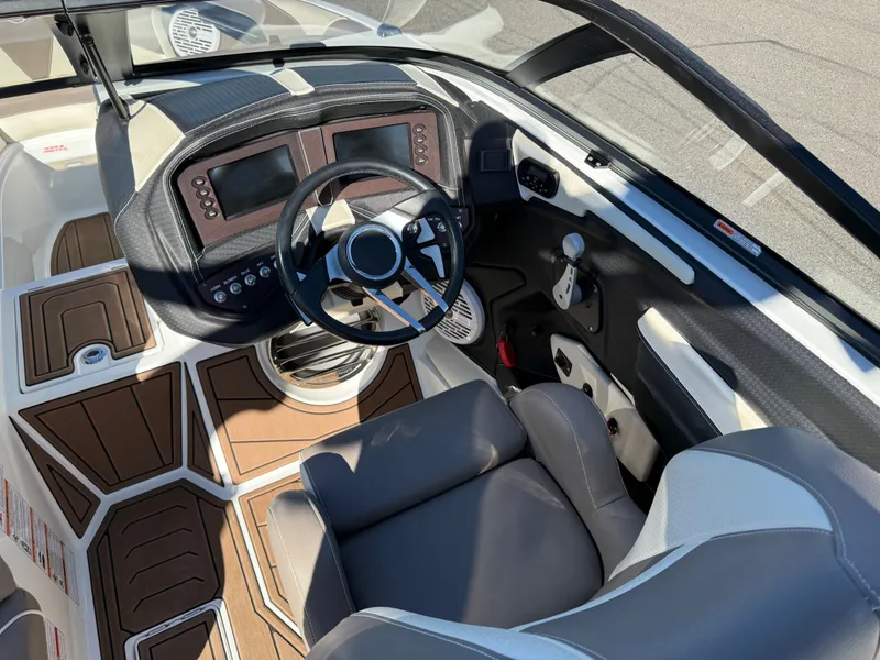 Slide: The Image of Interior of a 2020 Centurion Ri237 boat with modern helm console. - 9