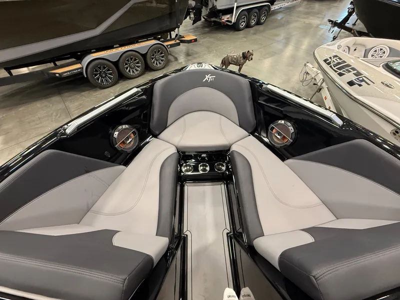 Slide: The Image of Interior of a 2022 MasterCraft XT21 boat with gray seating. - 10