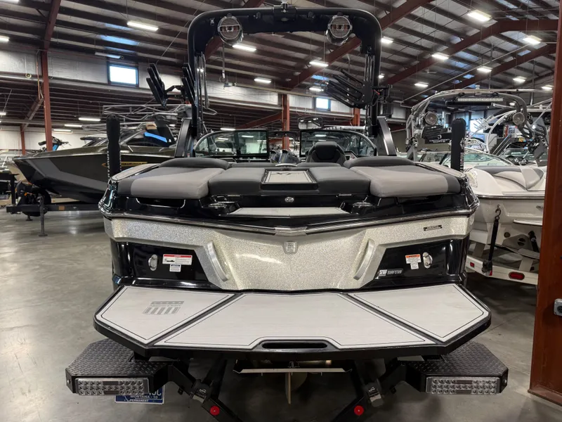 Slide: The Image of 2022 MasterCraft XT21 boat in showroom, rear view. - 4