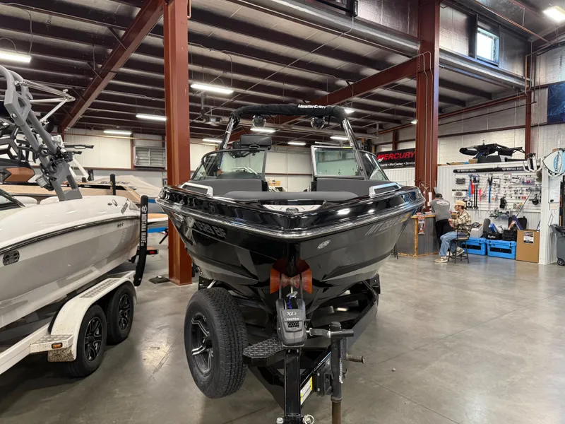 Slide: The Image of 2022 MasterCraft XT21 boat displayed in a workshop. - 6