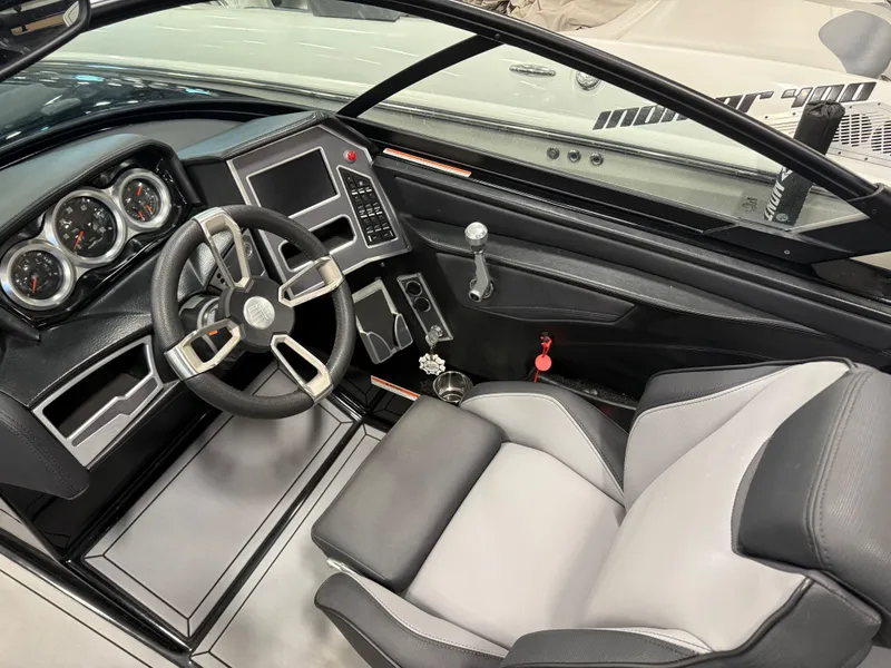 Slide: The Image of Interior of a 2022 MasterCraft XT21 boat with steering wheel and dashboard. - 7