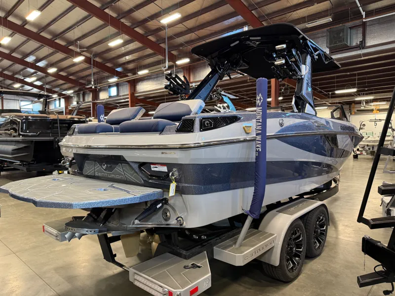 Slide: The Image of 2026 Centurion Fe23 boat in a warehouse on a trailer. - 13