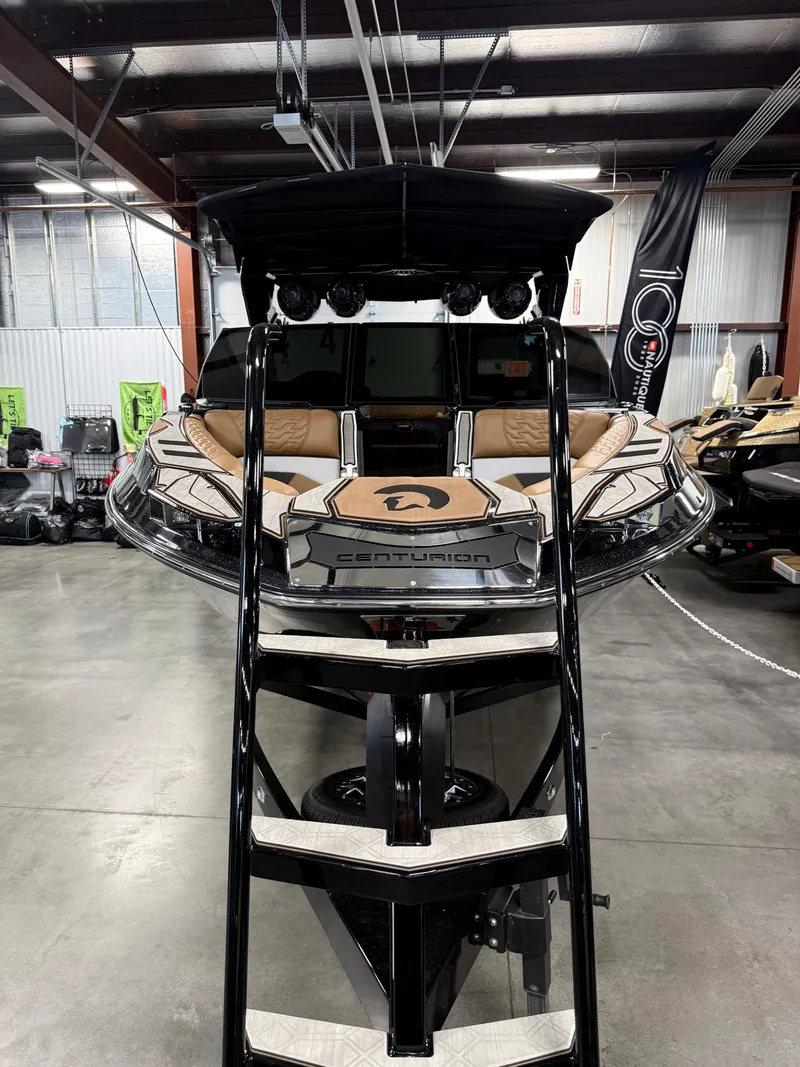 Slide: The Image of 2025 Centurion Ri245 boat displayed in a warehouse setting. - 6