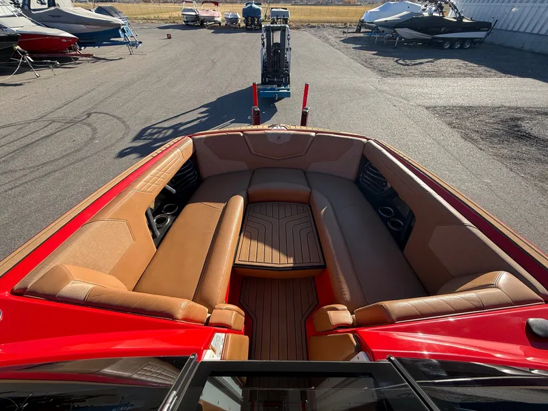 Slide: The Image of Interior of a 2021 Nautique G25 boat with brown seating. - 10