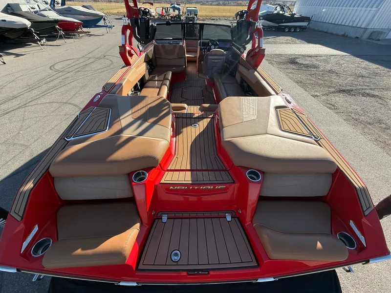 Slide: The Image of Interior view of a 2021 Nautique G25 boat with red accents. - 11