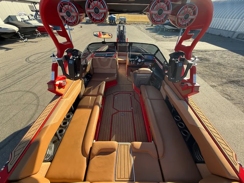 Slide: The Image of Interior view of a 2021 Nautique G25 boat with red accents. - 12