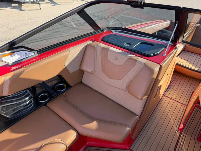 Slide: The Image of Interior of a 2021 Nautique G25 with brown leather seats. - 14