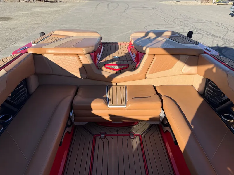 Slide: The Image of Interior of a 2021 Nautique G25 boat with brown leather seating. - 16