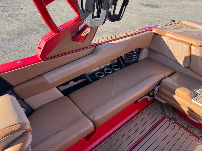 Slide: The Image of Interior of a 2021 Nautique G25 boat with brown seating. - 17