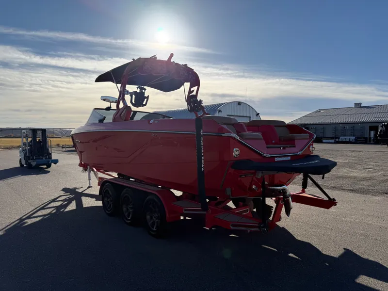 Slide: The Image of Red 2021 Nautique G25 boat on trailer at sunset. - 5