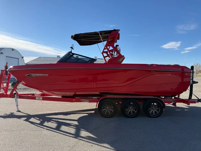Slide: The Image of Red 2021 Nautique G25 boat on trailer in sunny weather. - 6