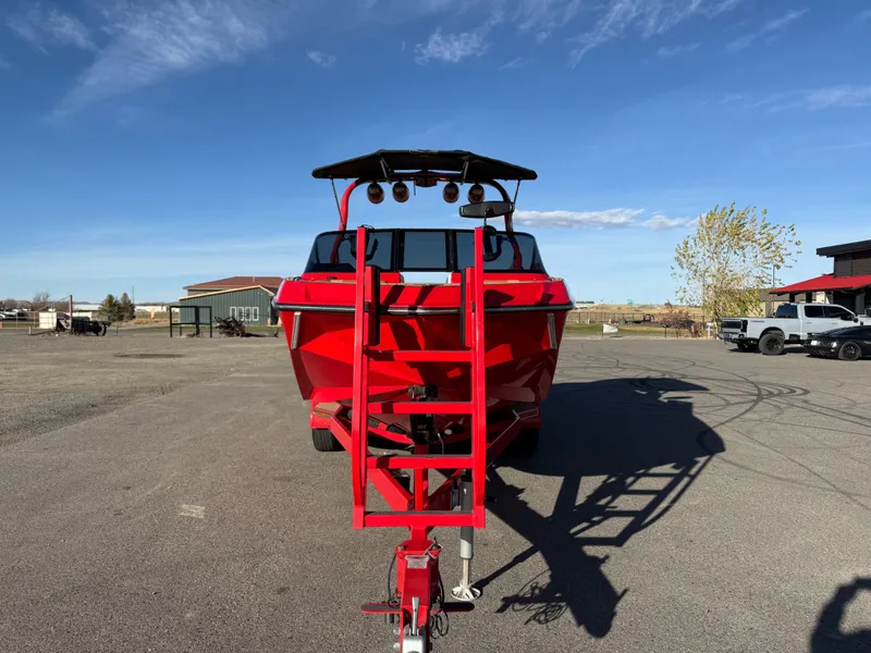 Slide: The Image of Red 2021 Nautique G25 boat on trailer, sunny day. - 8