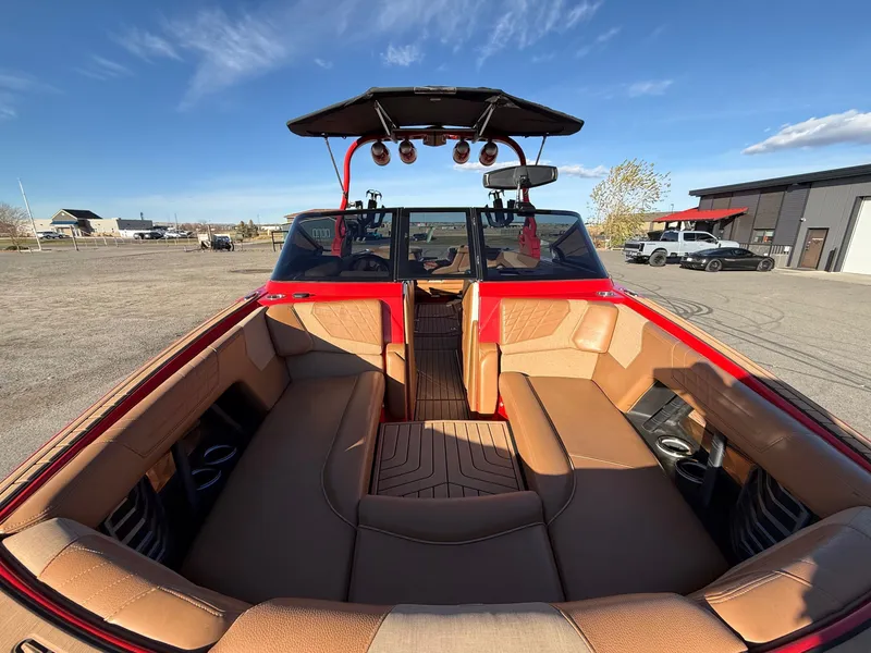 Slide: The Image of Interior of a 2021 Nautique G25 boat with brown seating. - 9