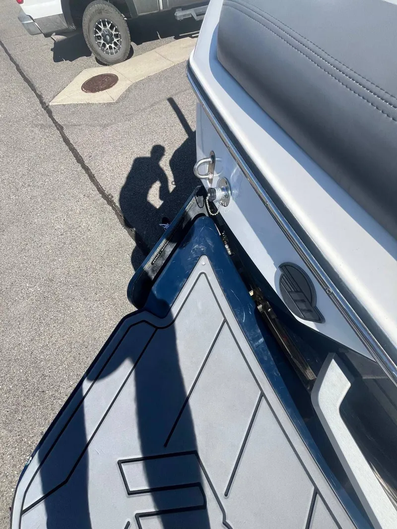 Slide: The Image of 2022 Malibu Wakesetter 22 LSV boat on a parking lot. - 21