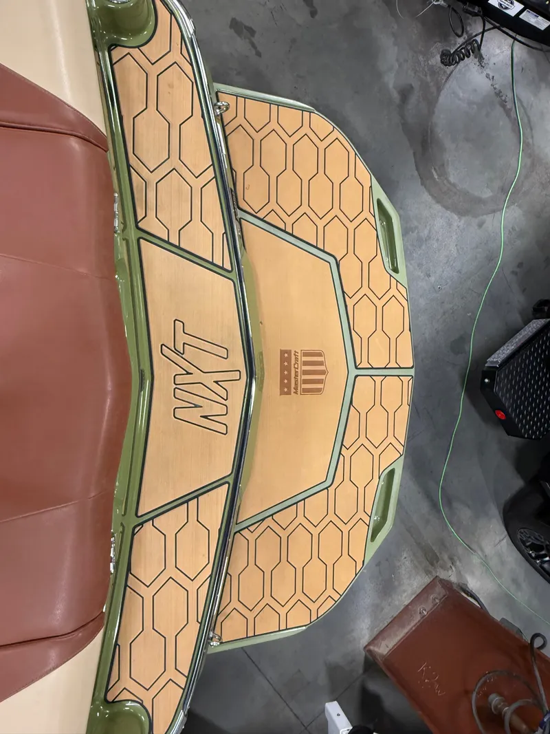 Slide: The Image of 2025 MasterCraft NXT23 boat rear with stylish design. - 4