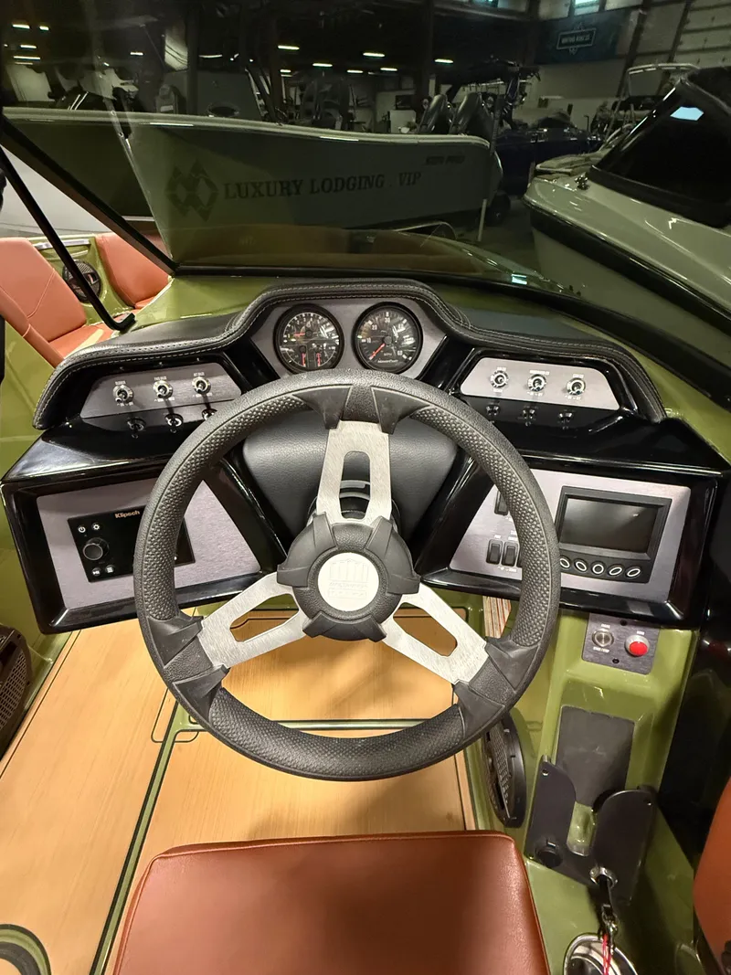 Slide: The Image of 2025 MasterCraft NXT23 helm with modern dashboard instruments. - 6