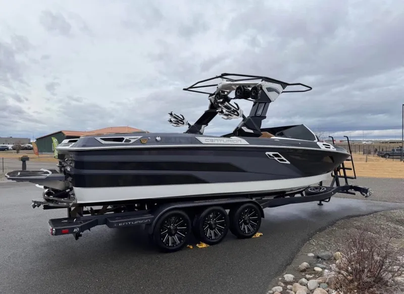 Slide: The Image of 2026 Centurion Ri 265 boat on trailer, black and white design. - 4