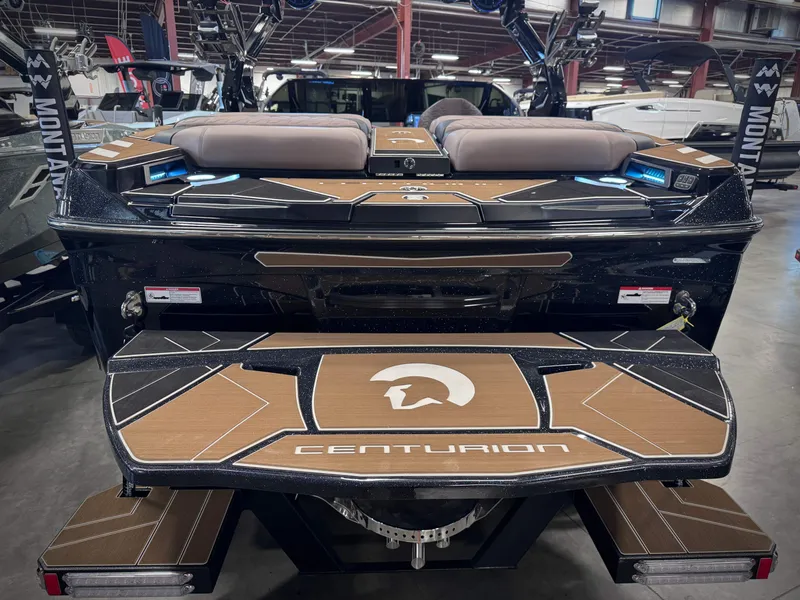 Slide: The Image of Rear view of Centurion Ri245 boat, 2026 model, in a warehouse. - 10