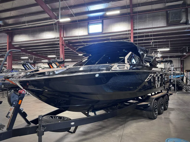 Slide: The Image of 2026 Centurion Ri245 boat in a warehouse on a trailer. - 22
