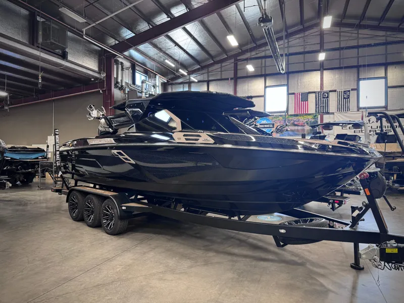 Slide: The Image of 2026 Centurion Ri245 boat in a warehouse setting. - 23