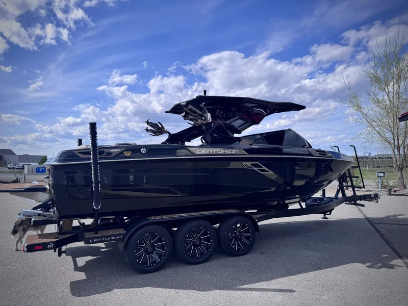 Slide: The Image of 2026 Centurion Ri245 boat on trailer under blue sky. - 24