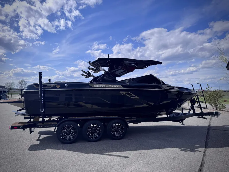 Slide: The Image of 2026 Centurion Ri245 boat on trailer under blue sky. - 25