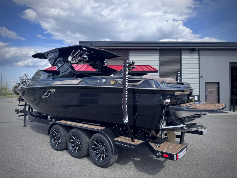 Slide: The Image of 2026 Centurion Ri245 boat on trailer outside warehouse. - 26