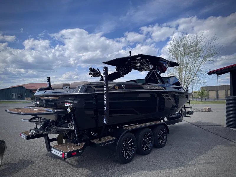 Slide: The Image of 2026 Centurion Ri245 boat on trailer under blue sky. - 28