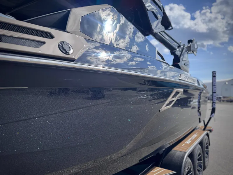 Slide: The Image of 2026 Centurion Ri245 boat gleaming under blue sky. - 30
