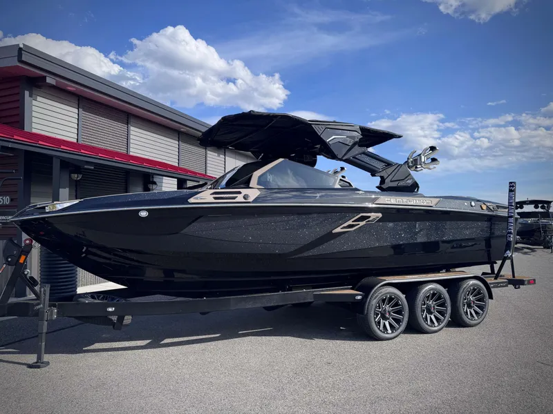 Slide: The Image of 2026 Centurion Ri245 boat on trailer in front of building. - 33