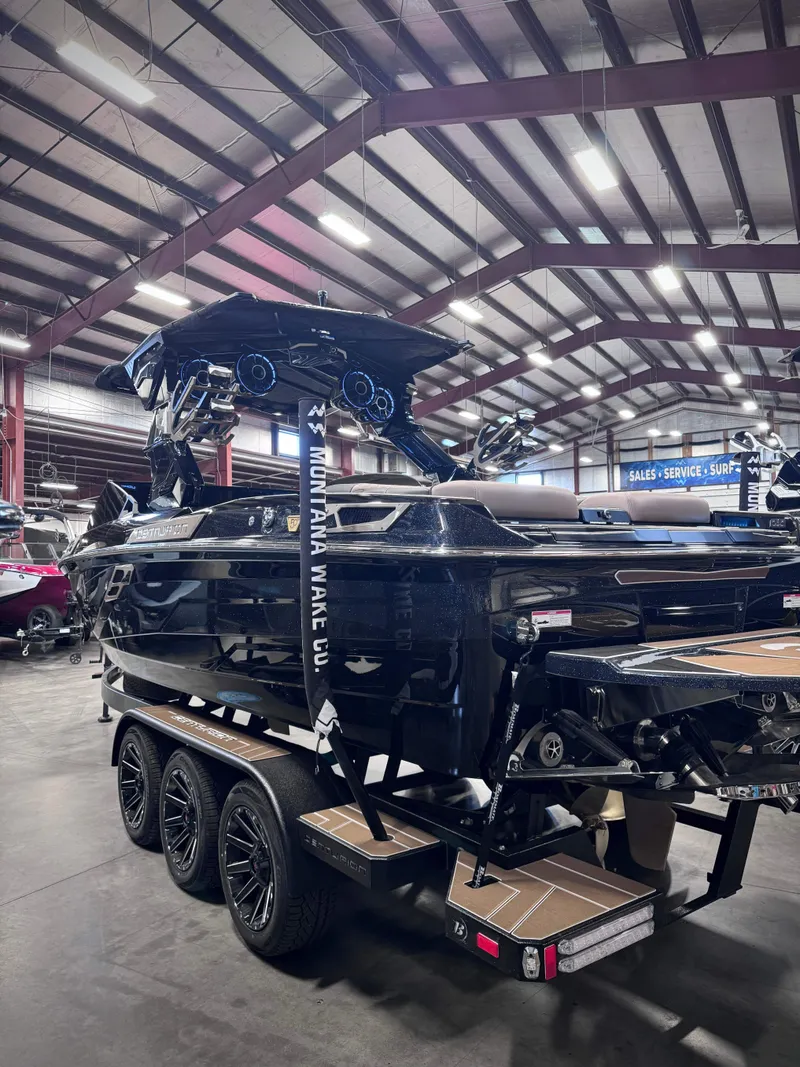 Slide: The Image of 2026 Centurion Ri245 boat in warehouse on trailer. - 8
