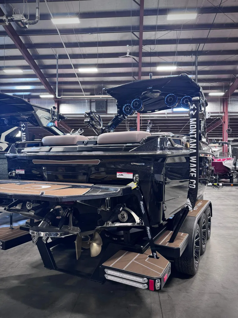 Slide: The Image of 2026 Centurion Ri245 boat in a warehouse, rear view. - 9