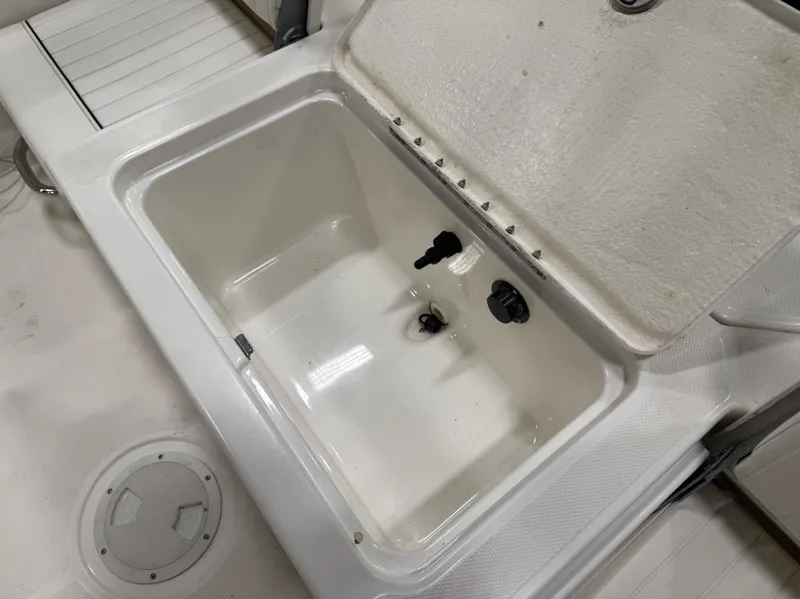 Slide: The Image of 2018 Bayliner Element F21 boat hatch with open storage compartment. - 10