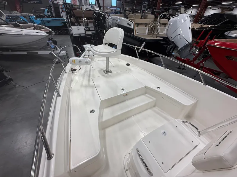 Slide: The Image of Interior view of a 2018 Bayliner Element F21 boat in showroom. - 17